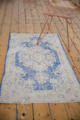 Distressed Oushak runner end, faded cobalt blue and antique ivory Rococo pattern.