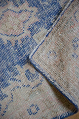 Vintage Distressed Oushak rug runner, showing worn cobalt blue and ivory pile, hand-knotted foundation.