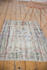 Distressed hand-knotted Oushak rug showing even wear, visible foundation, and muted colors.