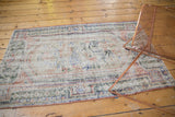 Vintage distressed Oushak rug border displaying even wear, foundation, and muted ivory, olive, blush.