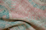 Textural detail of vintage distressed Oushak runner, highlighting worn knot heads and soft pastel hues.