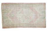 Vintage Distressed Oushak rug with faded dusty rose, beige, green, hexagonal floral medallion.