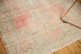 Distressed vintage Oushak rug pile, foundation showing through blush, pink, seafoam colors.