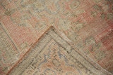 Distressed Oushak rug's blush pile and woven foundation, revealing even wear to knot heads.