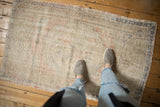 Textural view of a vintage distressed Oushak rug, highlighting worn pile and pale blush, ivory, cobalt hues.