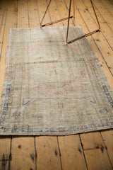 Textural detail of a distressed Oushak rug showing even wear and faded blush and blue patterns.