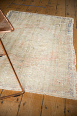 Vintage Oushak rug's distressed pile texture with even wear to foundation, muted colors.