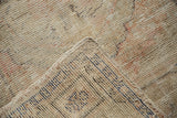 Distressed Oushak rug's worn pile texture with visible cobalt blue hand knotting.