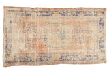 Vintage distressed Oushak rug, oval floral medallion, dusty blush, faded blue, worn pile.