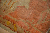 Textured low pile and knot heads of antique Oushak fragment with peach and gold vinery.