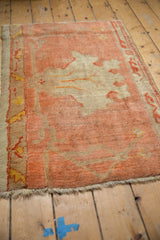 Antique Oushak rug's textured low pile, featuring peach and pale gold blossomed floral vinery.