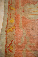 Secured edge and meandering vine border with peach, gold, brick red tones of an antique Oushak.
