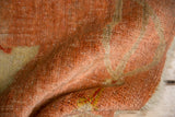 Close-up of antique Oushak rug's low pile, revealing even wear and rich peach, saffron tones.