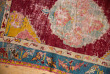 Saffron yellow corner spandrel and worn floral medallion of an antique Anatolian rug.