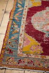 Original poly-chrome side cord and wear to knot heads on the corner of an antique Anatolian rug.