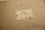 Reverse of vintage still life painting canvas board, Weber label and paint residue.