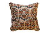 Vintage Kurdish rug fragment flower pillow, rich beige, blue, rust palette, decorative texture, 16x16.