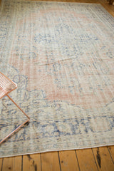 Distressed vintage Oushak carpet, pale blush, ivory, blue floral motifs, faint foundation.