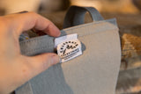 Close-up of the gray wool felt showing the stitched Oxford Pennant 