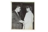 Black and white 1945 candid photograph of David Selznick greeting Ingrid Bergman with cigarette.