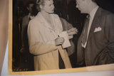 Vintage black and white photograph of Ingrid Bergman speaking with a gentleman, showing age.