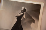 Angled view of the vintage Carole Lombard photograph, showing the classic portrait and the print's white border.