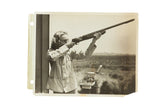 Vintage photograph of Carole Lombard aiming a shotgun at a skeet shooting range.