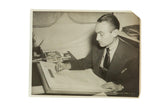 Vintage photograph of Walter Plunkett, Gone with the Wind costume designer, sketching a dress.