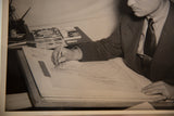 Vintage photograph close-up of costume designer sketching a famous drapery dress.