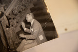 Candid photograph of Director Victor Fleming with ornate stairwell and visible age wear.