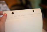 Back of vintage photograph showing handwritten 'Walter Plunkett = Costume Designer' and two punch holes.