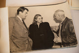 Ingrid Bergman, Gregory Peck, and director in candid vintage photograph conversation.