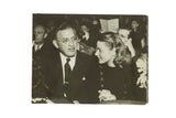 Candid vintage photograph of actress Ingrid Bergman and David Selznick sitting together in a theater.