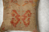 Textured close-up of vintage Turkish rug fragment pillow, showing distressed butterfly motif.