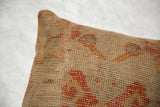 Textured vintage Turkish rug fragment pillow, showcasing aged weave and subtle orange patterns.