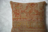 Woven texture and distressed geometric patterns in rust orange and gold on vintage Turkish pillow.