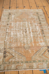 Texture of distressed vintage Oushak rug showing worn knot heads and pale terra cotta tones.
