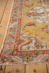 Distressed vintage Oushak runner texture, gold field, red geometric border, visible foundation wear.