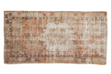 Distressed vintage Oushak runner, faded terra cotta and ivory medallion with mostly even wear.