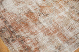 Distressed vintage Oushak rug texture with pale terra cotta, ivory, and muted dark tones.