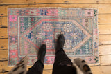 Distressed Oushak rug with soft pink, blue, green hues and charming worn texture.