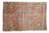 Vintage distressed Oushak rug, stepped medallion, pale blue, terra cotta, pink, and mint green.