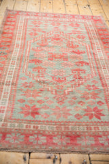 Distressed texture and faded raspberry, silver slate star patterns on this Oushak rug end.