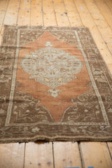 Distressed Oushak rug, light central medallion, abrashed chestnut brown field, even pile wear.