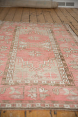 Vintage Distressed Oushak rug, dusty blush, ivory, and brown hook and latch patterns.