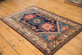 Intricate traditional geometric border of beige and brown on a vintage Hamadan rug corner.
