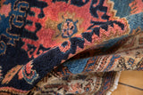 Hand-knotted pile of a vintage Hamadan rug, showing navy, red, and gold Mahi Mahi pattern.