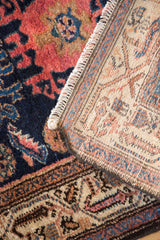 Hand-knotted foundation and rich navy, coral pile of a vintage Persian Hamadan rug.