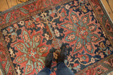 Antique Heriz rug with serrated leaf border featuring navy, wine red, and oxidized green vinery.