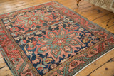 Serrated leaf main border with oxidized copper green vinery on an antique Heriz rug.